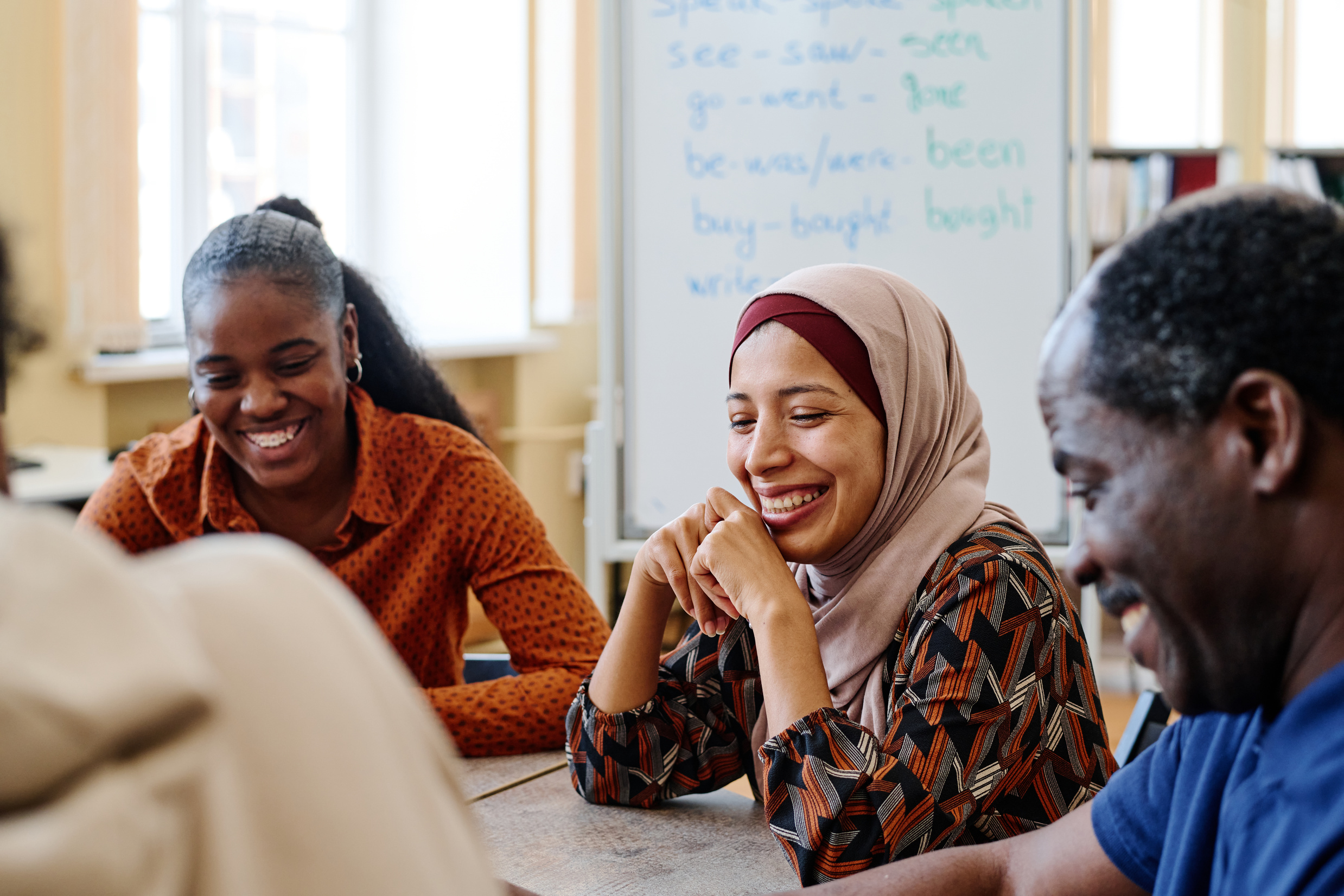 Aliya smiling with other participants during a workplace learning session